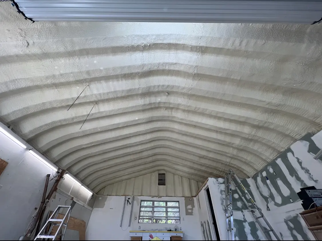 Spray polyurethane foam applied to the underside of a metal roof deck in Gantt